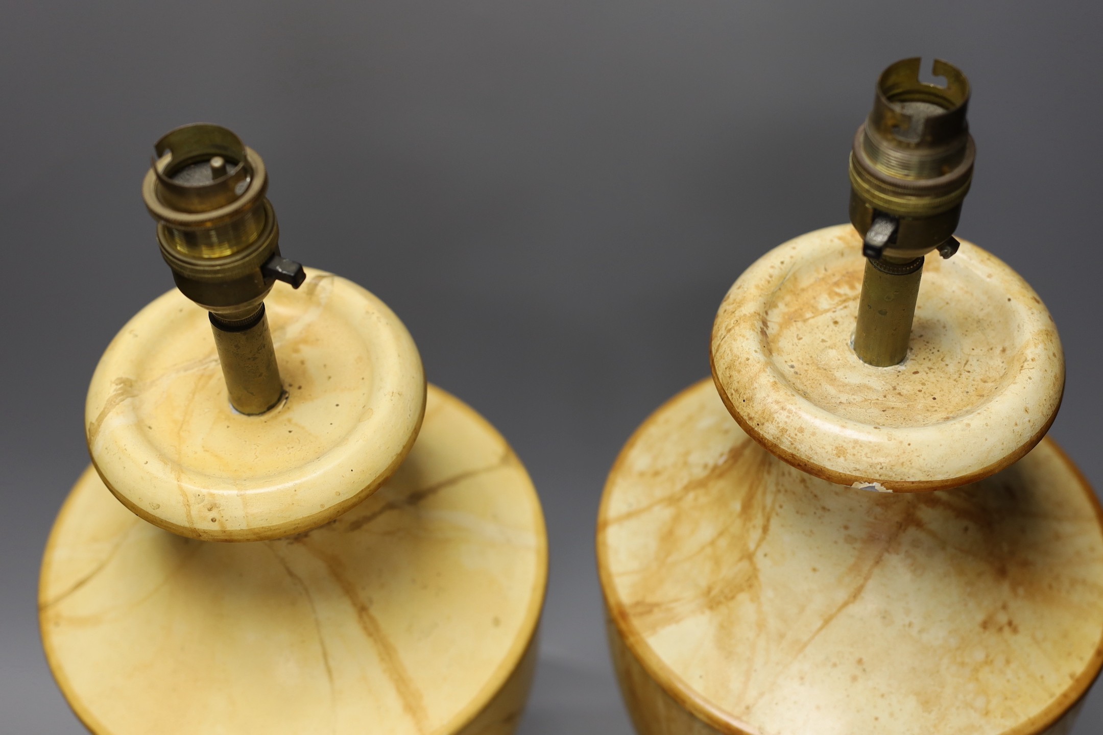A pair of faux marble toleware style lamps, 41 cms high not including fittings